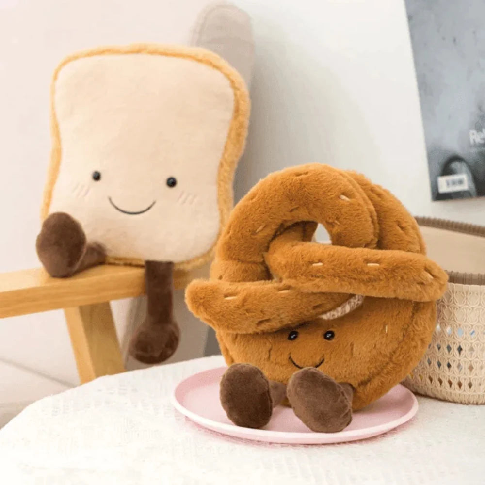 Baguette plush toy displayed on bed showcasing elongated bread shape and attached limbs for hugging