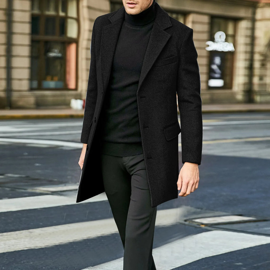 Close-up view of men's tailored overcoat showing structured fabric and flap pocket detail