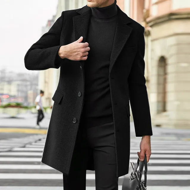 Side profile of men's tailored overcoat displaying mid-thigh length and single-breasted design