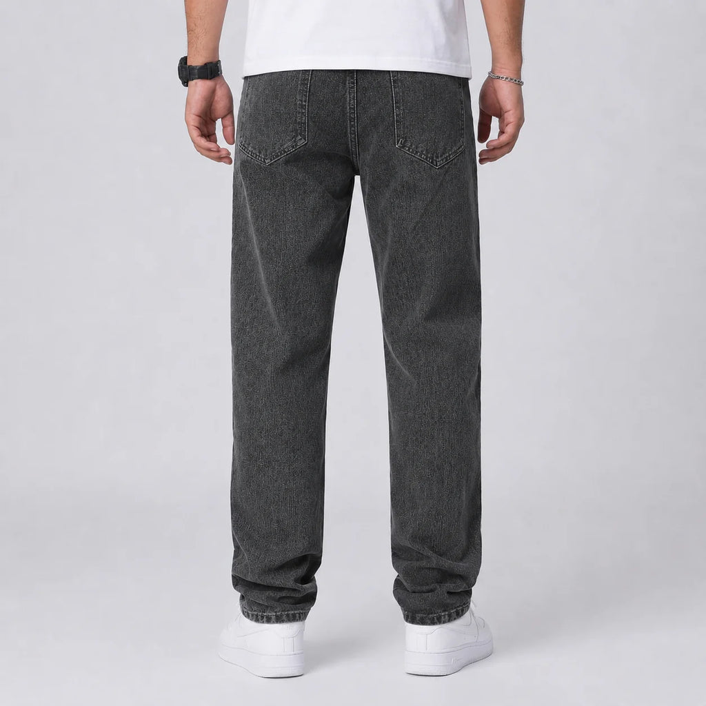 Full length view of men's relaxed fit wide leg jeans in light blue denim