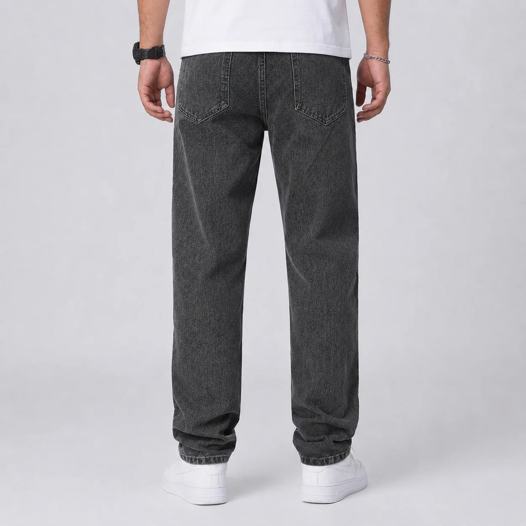 Full length view of men's relaxed fit wide leg jeans in light blue denim