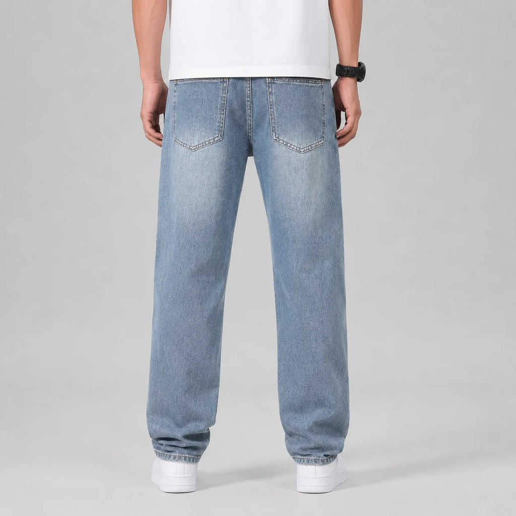 Close-up of men's wide leg jeans showing denim texture and relaxed straight cut