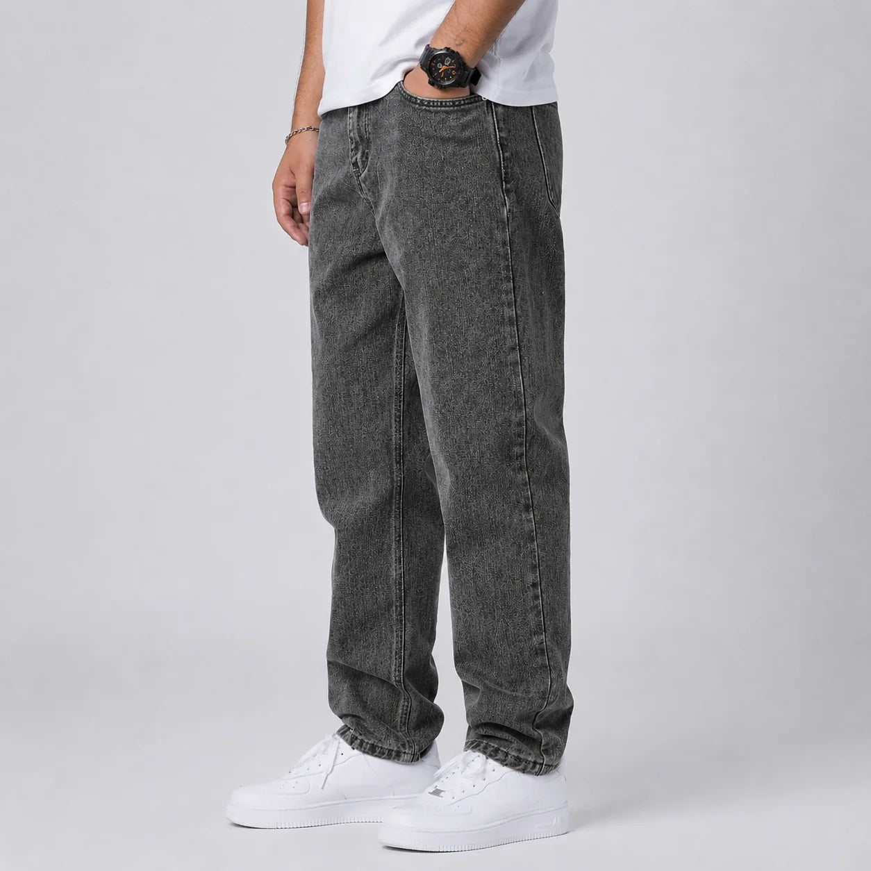 Men's wide leg jeans styled with white high-top trainers for casual weekend look