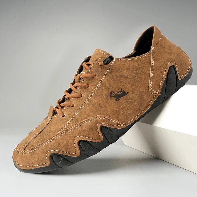 Side profile of men's casual trainers showing contrast stitching and textured sole detail