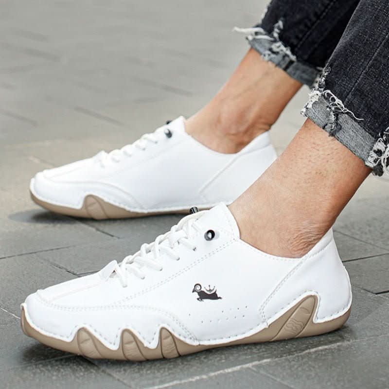 Detailed view of men's casual trainers with wavy sole pattern and adjustable lace closure