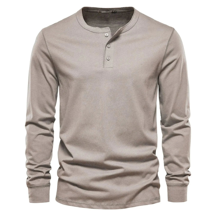 Close-up view of men's henley showing three-button neckline and ribbed collar detail