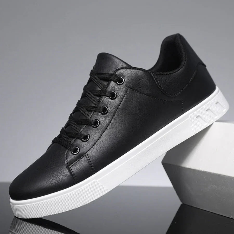 Side view of men's trainers showing clean low-top silhouette and structured upper