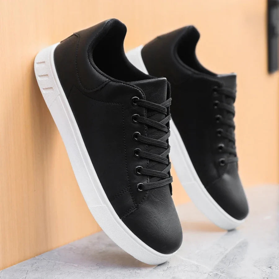 Men's trainers from above showing lace-up closure and minimalist design