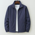 Men's navy zip-up casual jacket with stand collar and elasticated cuffs on hanger