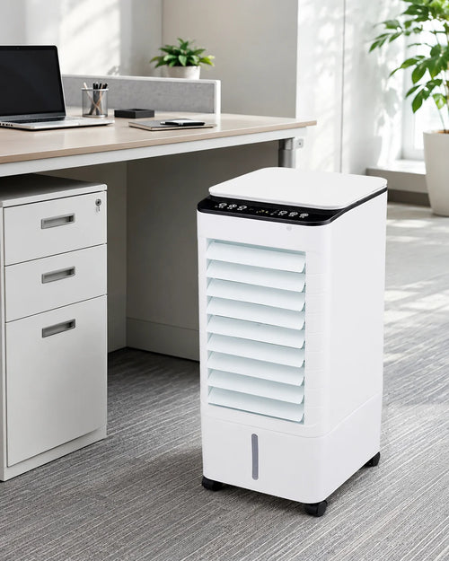 Portable air cooler with remote control in white finish positioned beside office desk with louvred front panel
