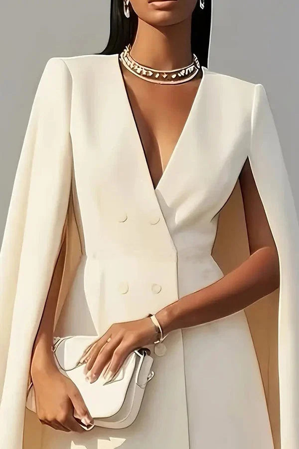 Back view of cape mini dress with flowing cape sleeves and above-knee hemline