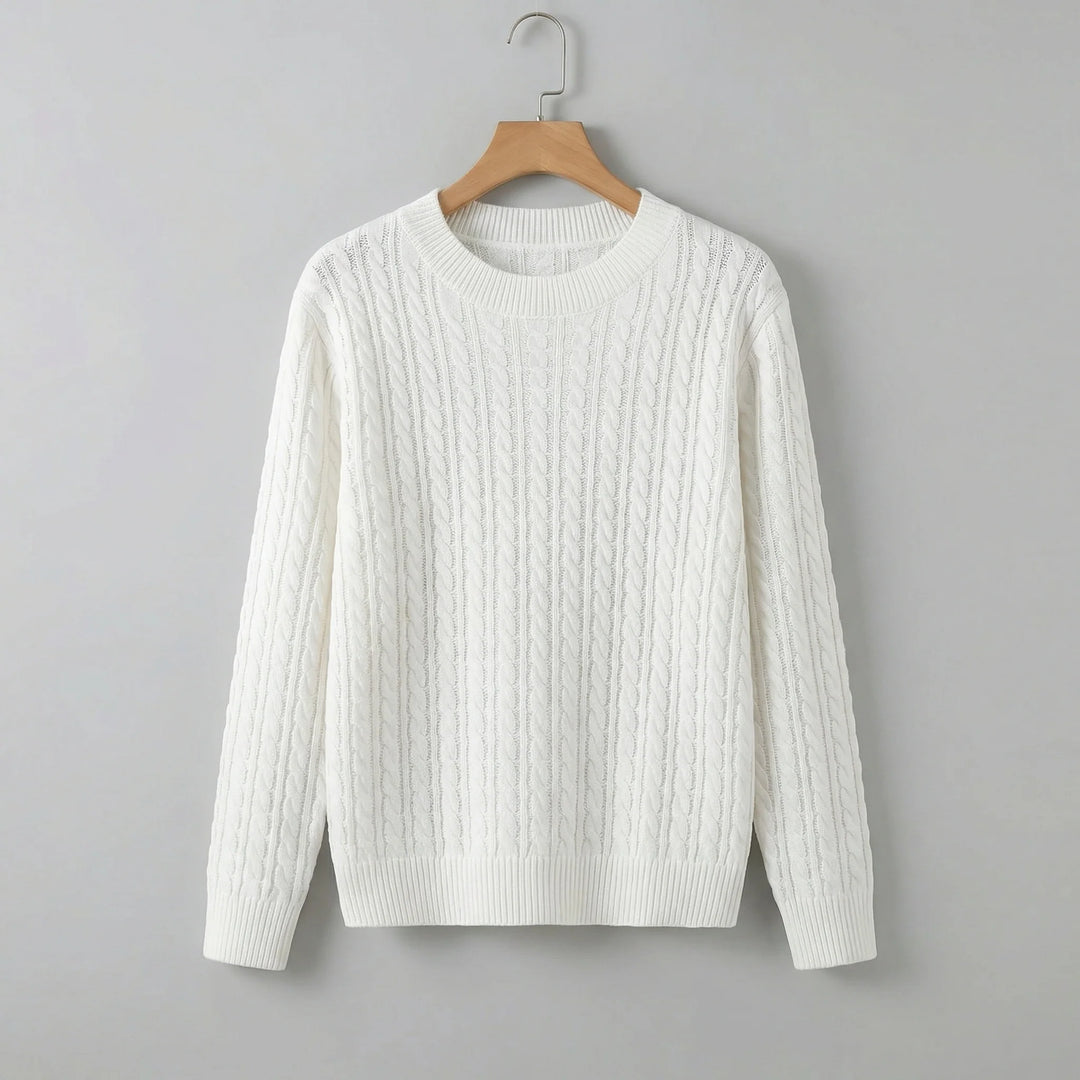 White cable knit jumper with crew neck and relaxed fit hanging on wooden hanger