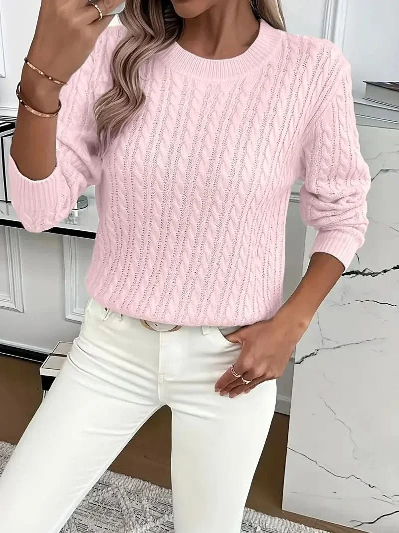 Close-up of cable knit detailing and ribbed neckline on crew neck jumper