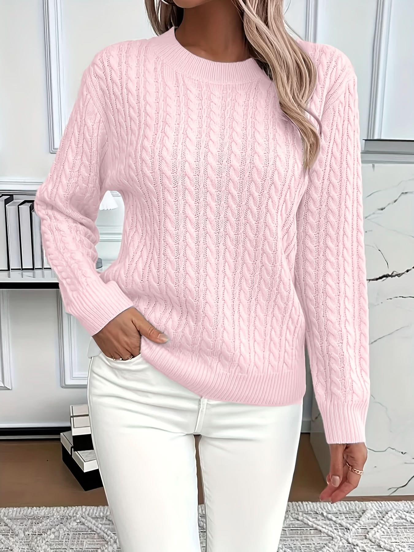 Side view showing relaxed silhouette and ribbed cuff detailing on cable knit jumper
