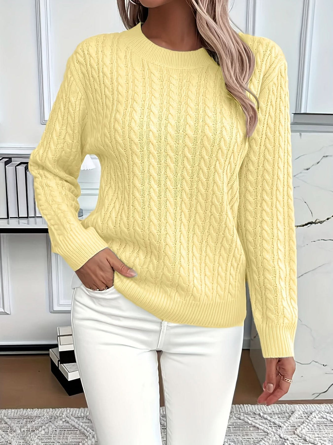 Detail of cable knit pattern and ribbed hem on relaxed fit jumper