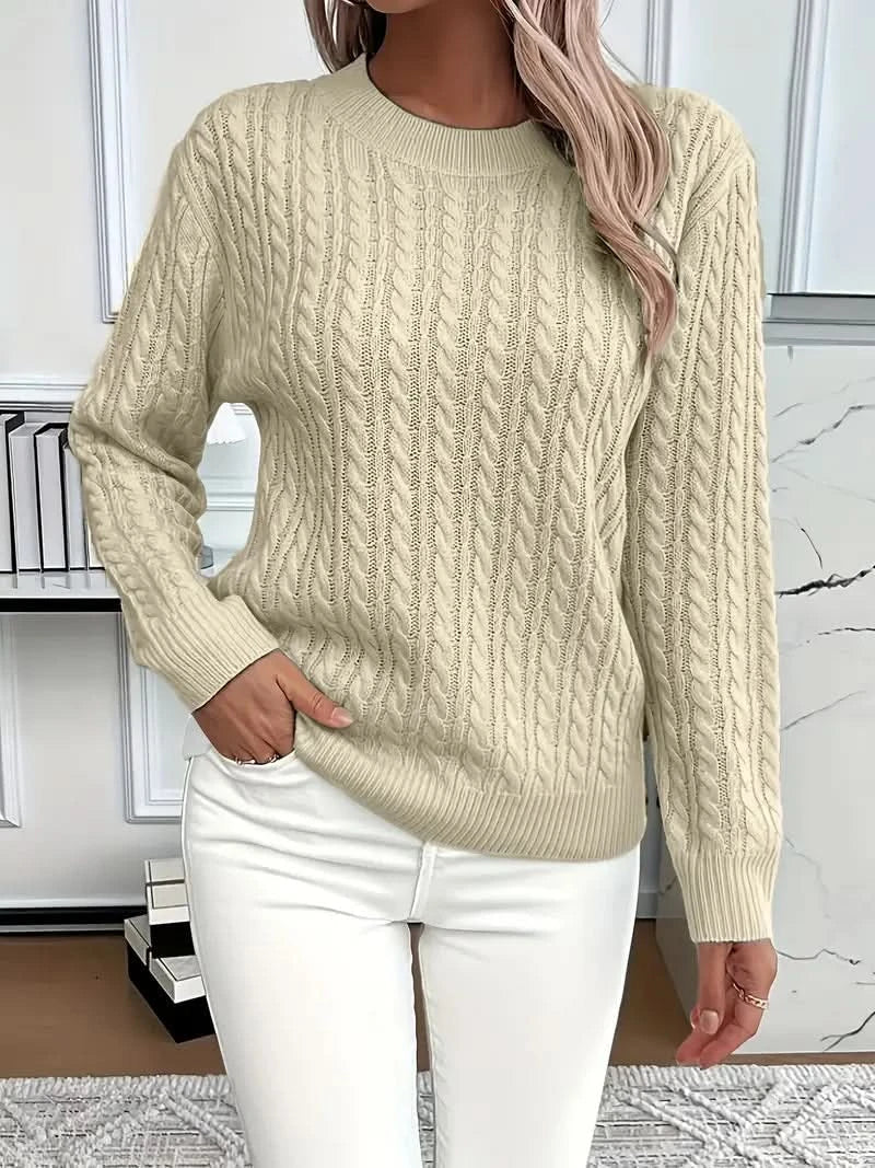Front view of white cable knit jumper with classic crew neck design