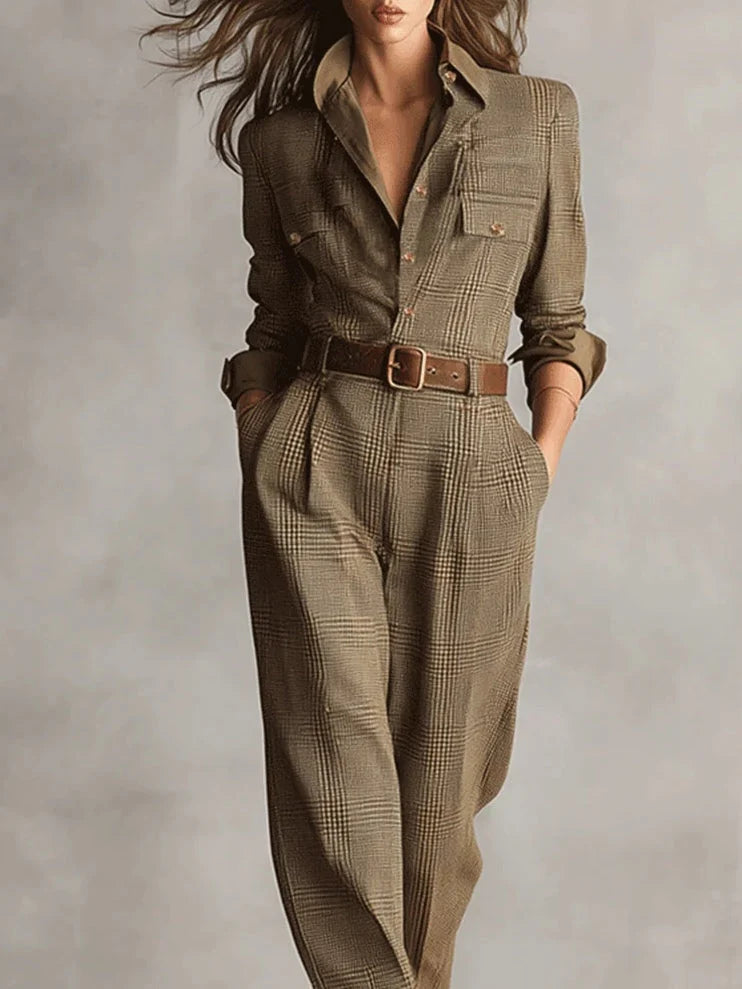 Close-up of checked tailored jumpsuit showing structured bodice, button closure, and chest pocket detail