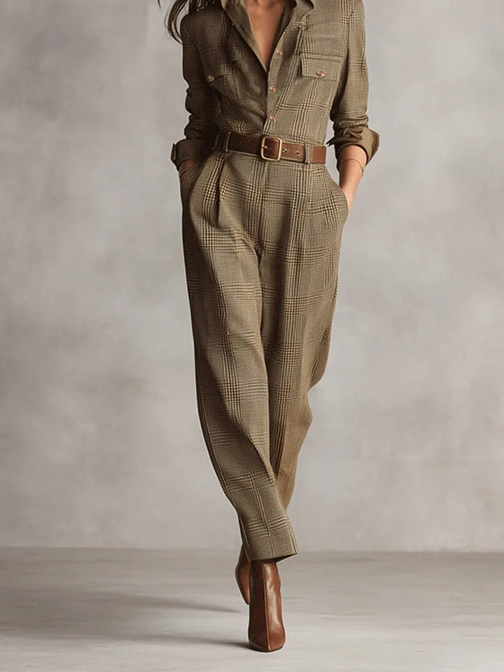 Side view of women's belted checked jumpsuit highlighting relaxed fit and full-length tapered leg