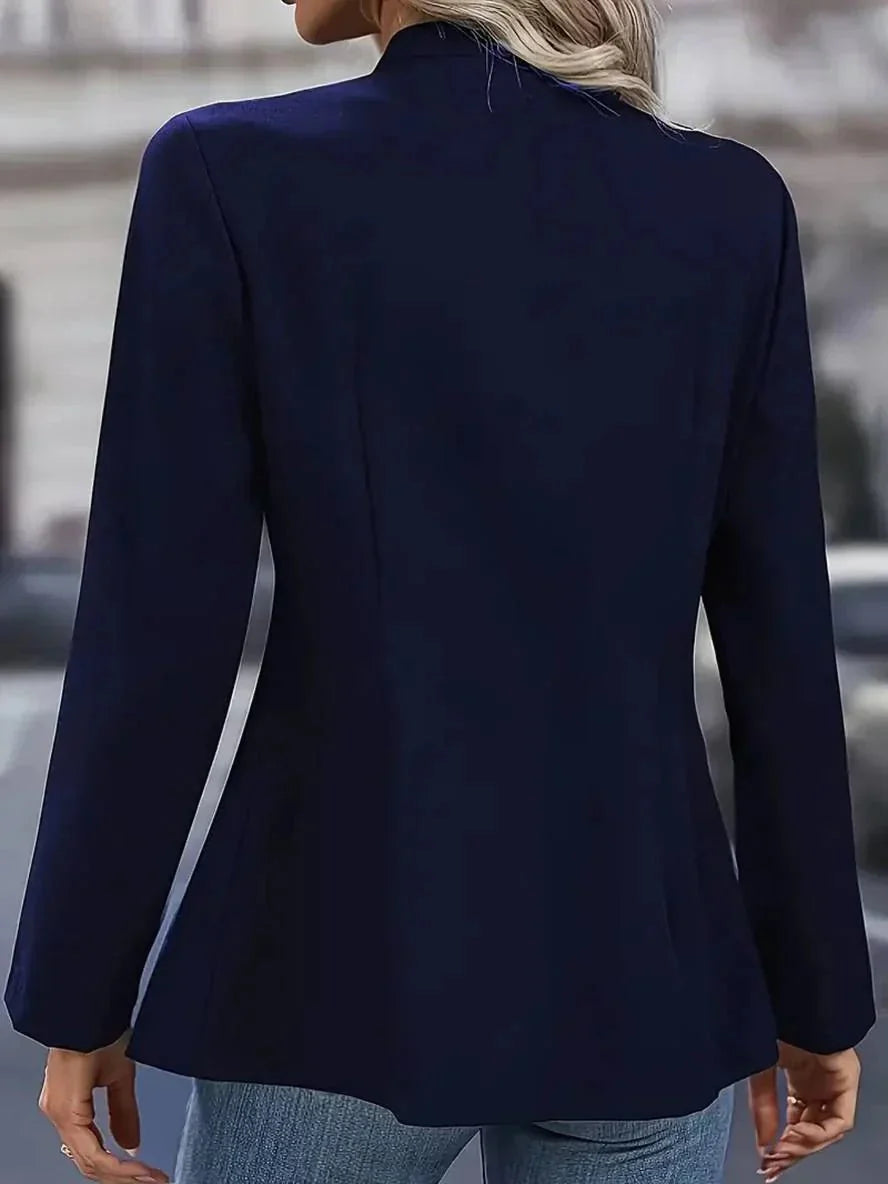 Side view of structured women's blazer with fitted waist and long sleeves