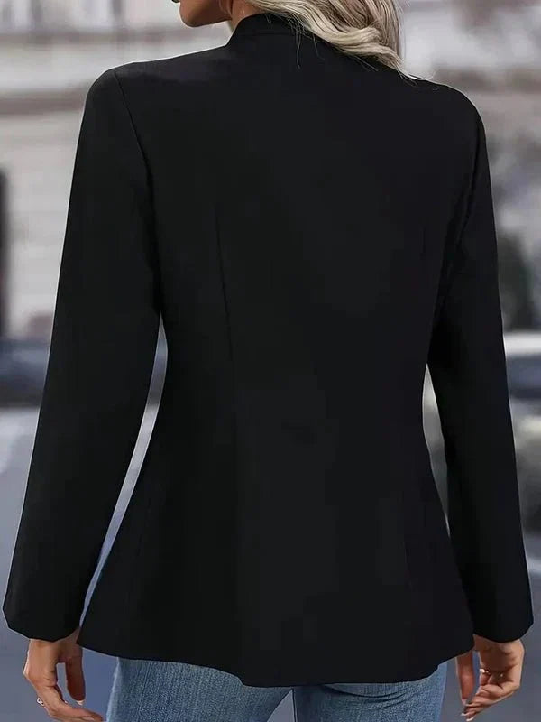 Women's tailored blazer in navy showing collarless neckline and open front design