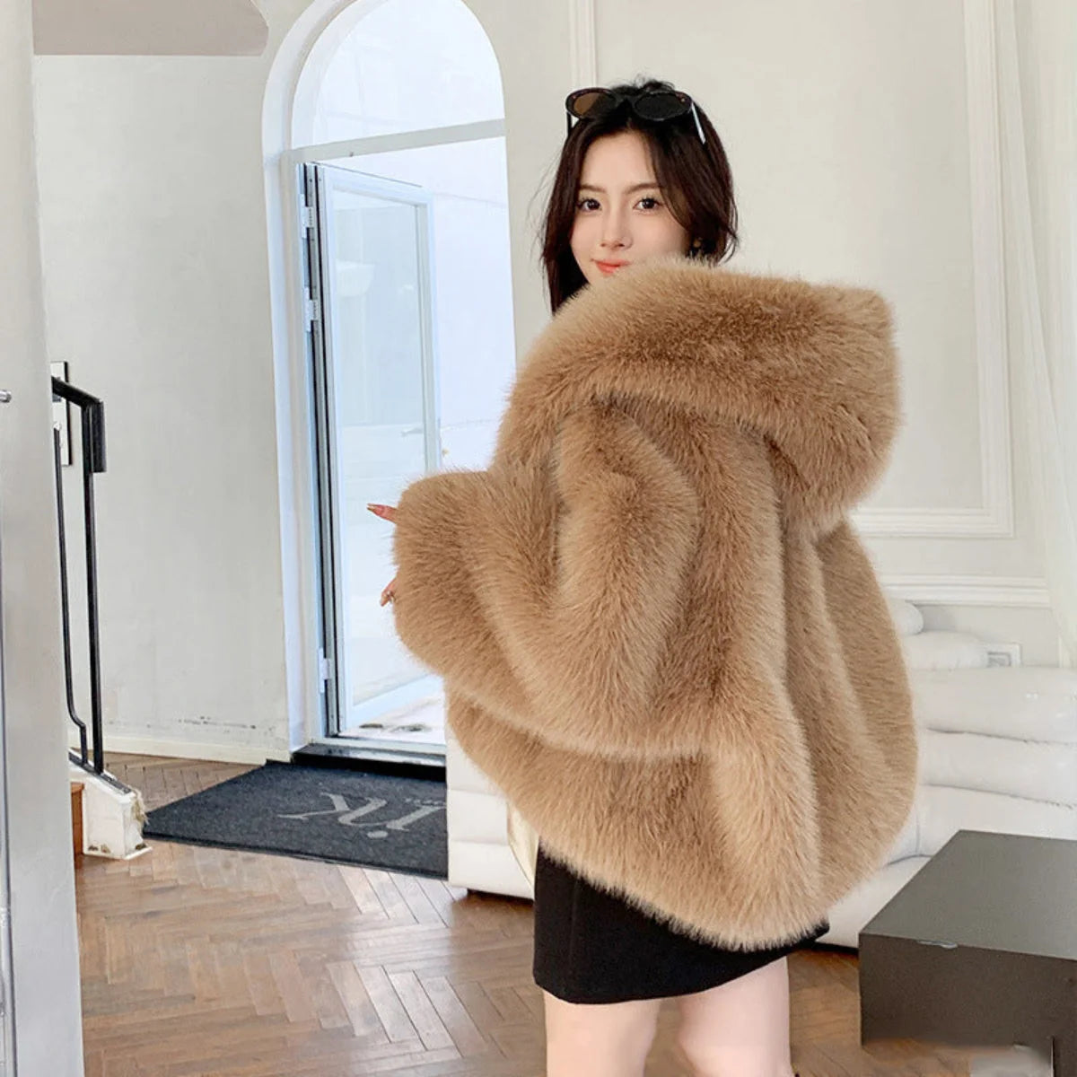 Draped faux fur coat with structured fabric and oversized proportions for evening wear
