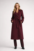 Women's long burgundy trench coat with double-breasted closure and tie belt, ankle-length silhouette with notched lapels