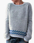 Women's striped crew neck jumper with horizontal knit stripes and blue zigzag detail above the ribbed hem