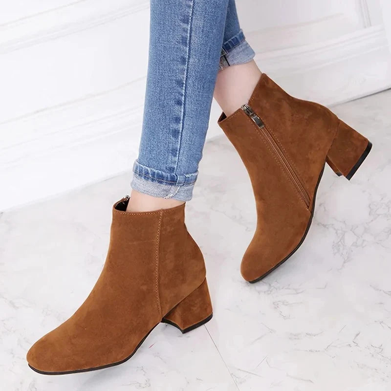 Women's suede ankle boots in tan with block heel and side zip, styled with rolled-up jeans