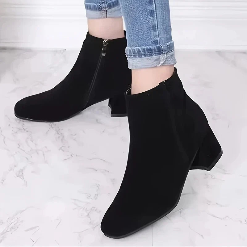 Side view of women's suede ankle boots displaying side zip fastening and textured finish
