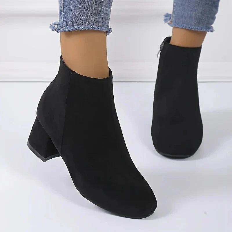 Rear view of women's tan suede ankle boots showing block heel and ankle-height silhouette