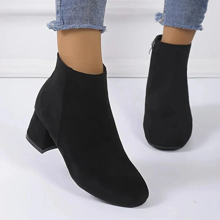 Rear view of women's tan suede ankle boots showing block heel and ankle-height silhouette