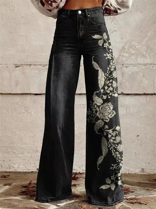 Women's high-waist wide-leg jeans in dark wash with floral embroidery detail running along the outer leg