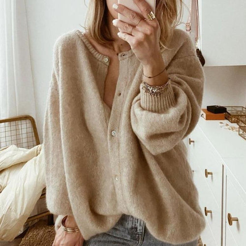Women's oversized knit cardigan in taupe with button front and ribbed cuffs, worn over jeans