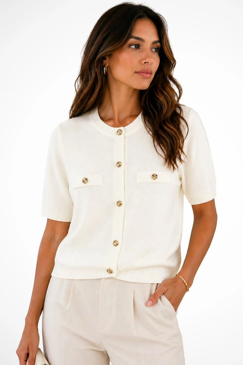 Close-up view of women's short sleeve knit cardigan showing gold-tone buttons and round neckline