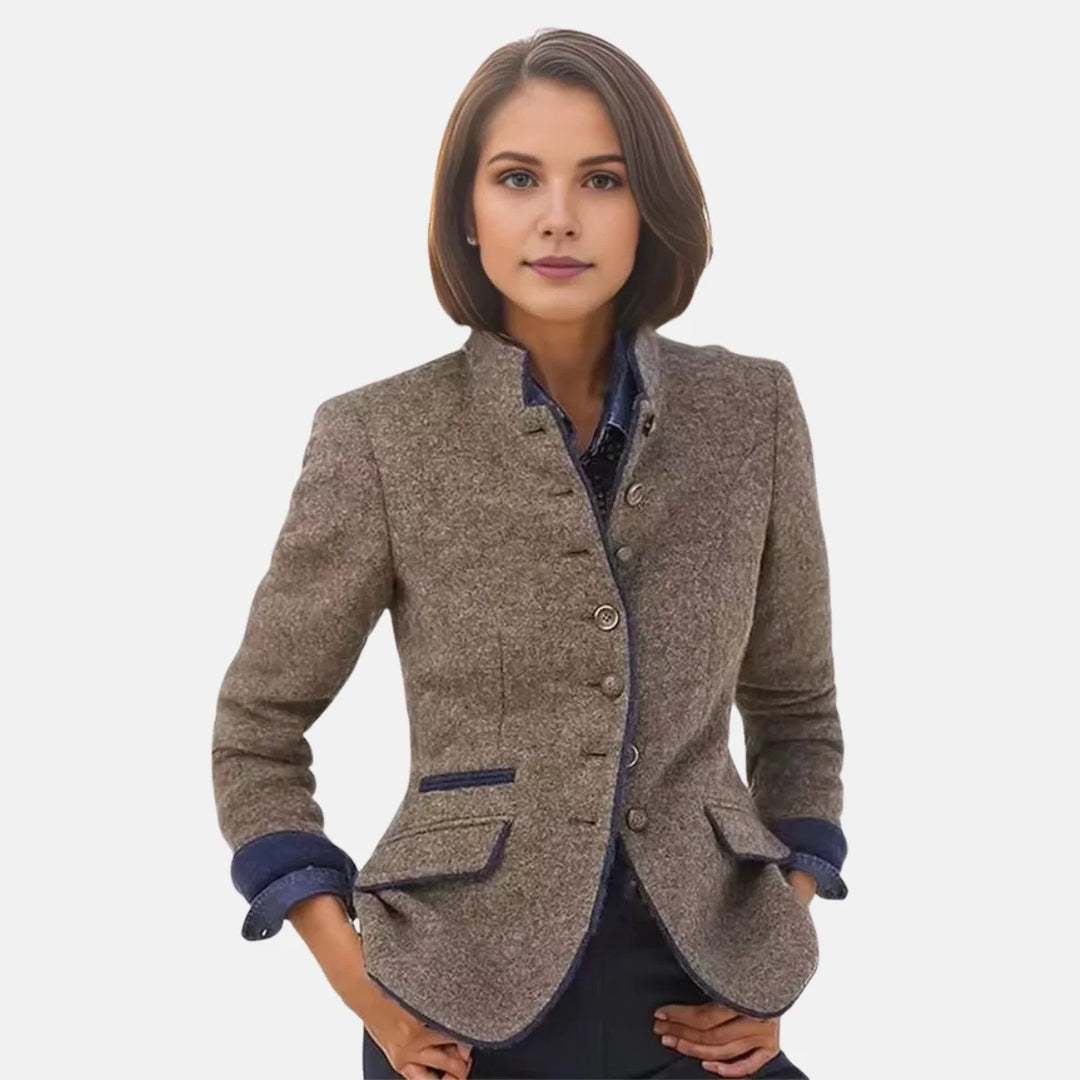 Women's tailored blazer in brown with stand collar and contrast navy trim detail at cuffs