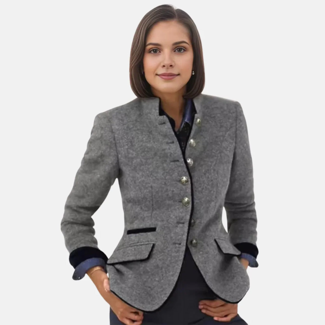 Close-up view of women's structured blazer showing button-front closure and fitted waist detail