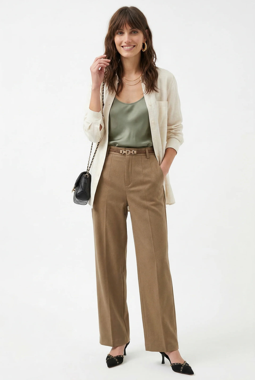 Beige wool trousers styled with sleeveless black top for contemporary office outfit