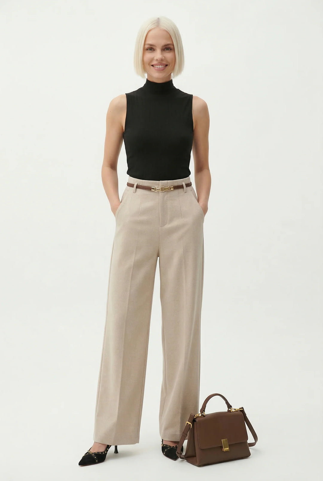 Women wearing tailored wide leg wool trousers in beige with structured silhouette