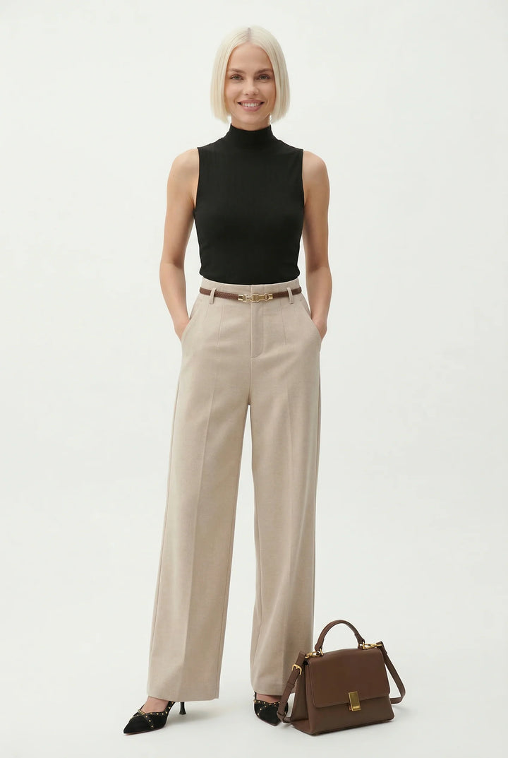 Women wearing tailored wide leg wool trousers in beige with structured silhouette