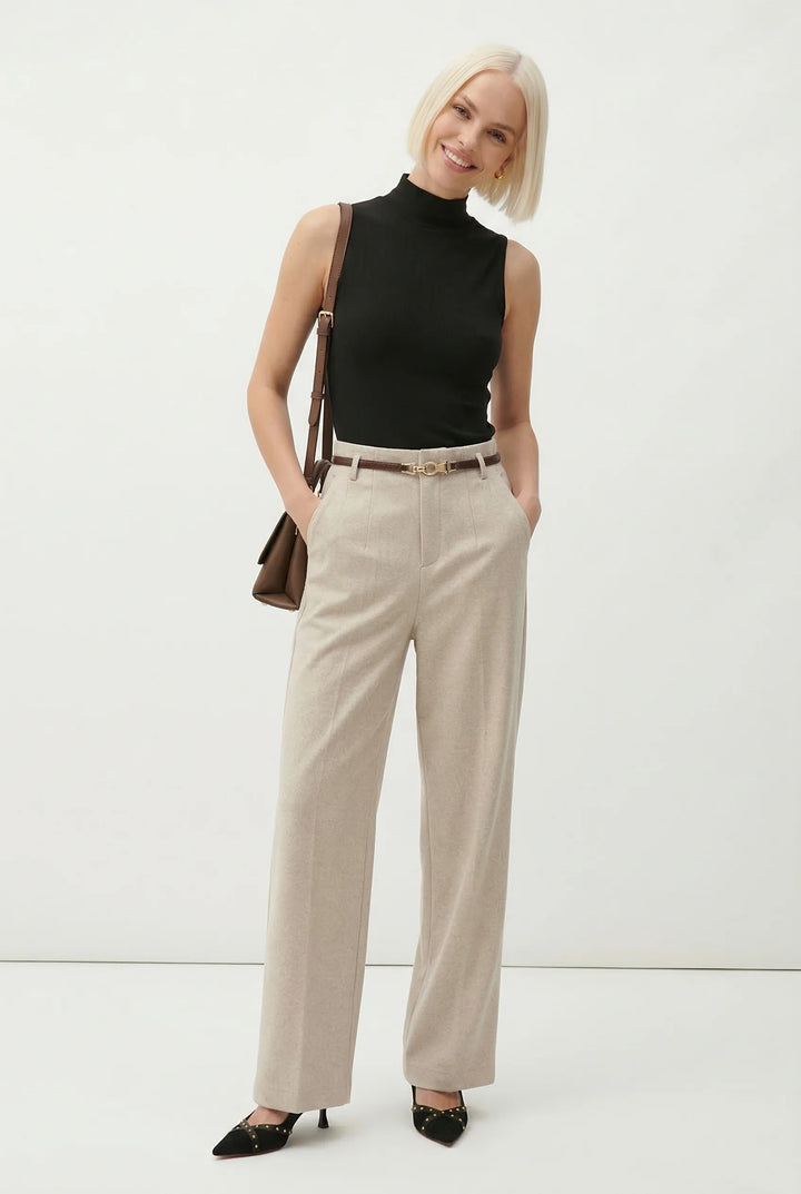 Detail of wool trousers fabric texture showing smooth woven finish