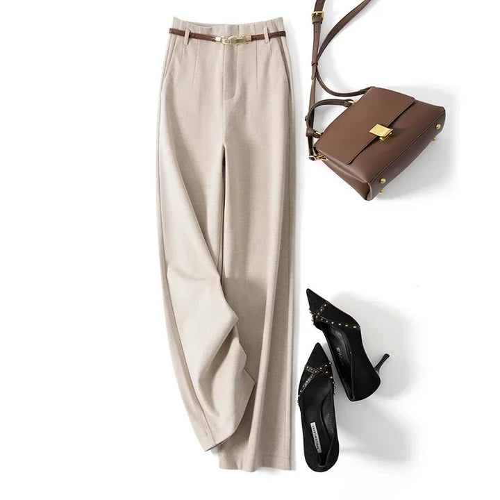 Side view of beige wool trousers showing wide leg drape and full length