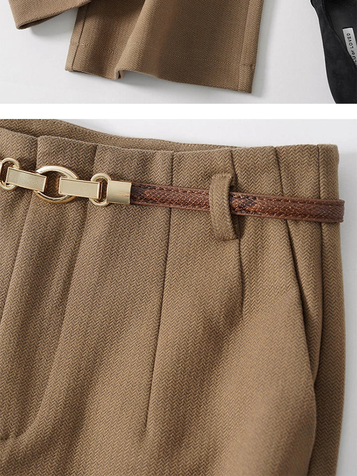 Close-up of wool trousers belt and waistband detail with pressed pleats