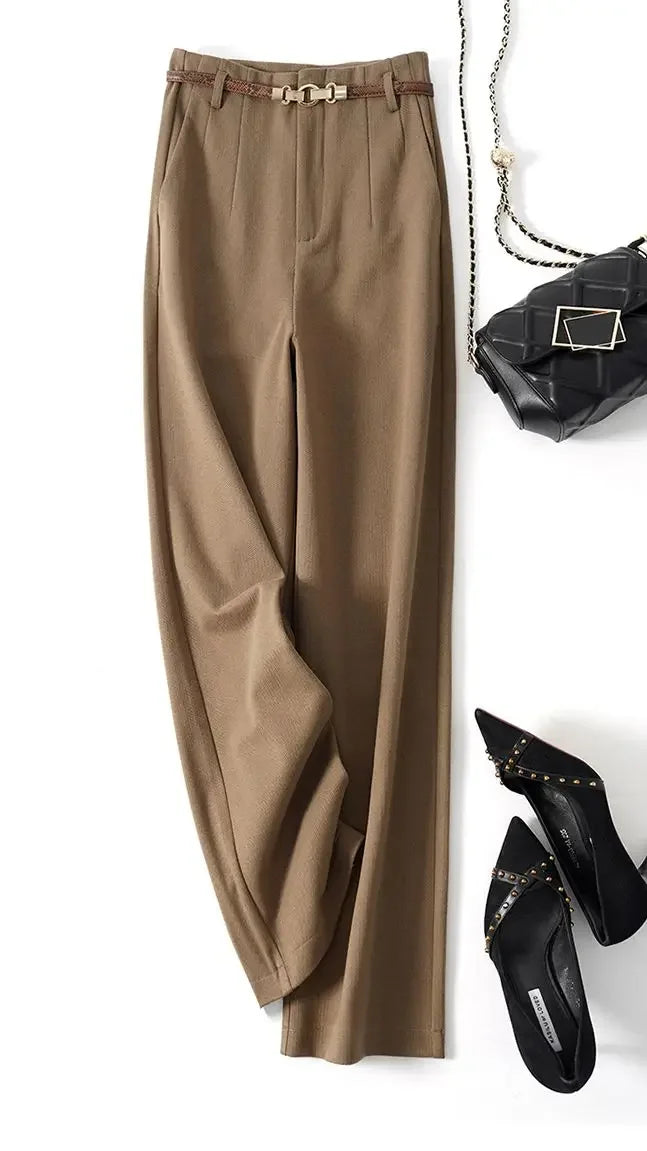 Detail of beige wool trousers fabric showing smooth texture and crisp finish
