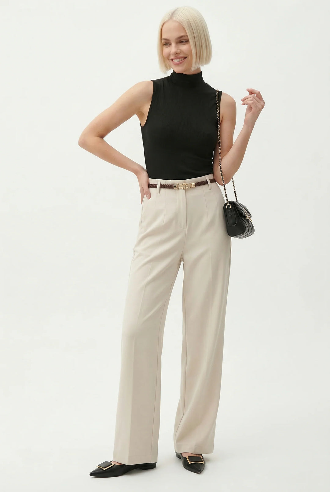 Full length view of tailored wool trousers with high waist and pressed creases