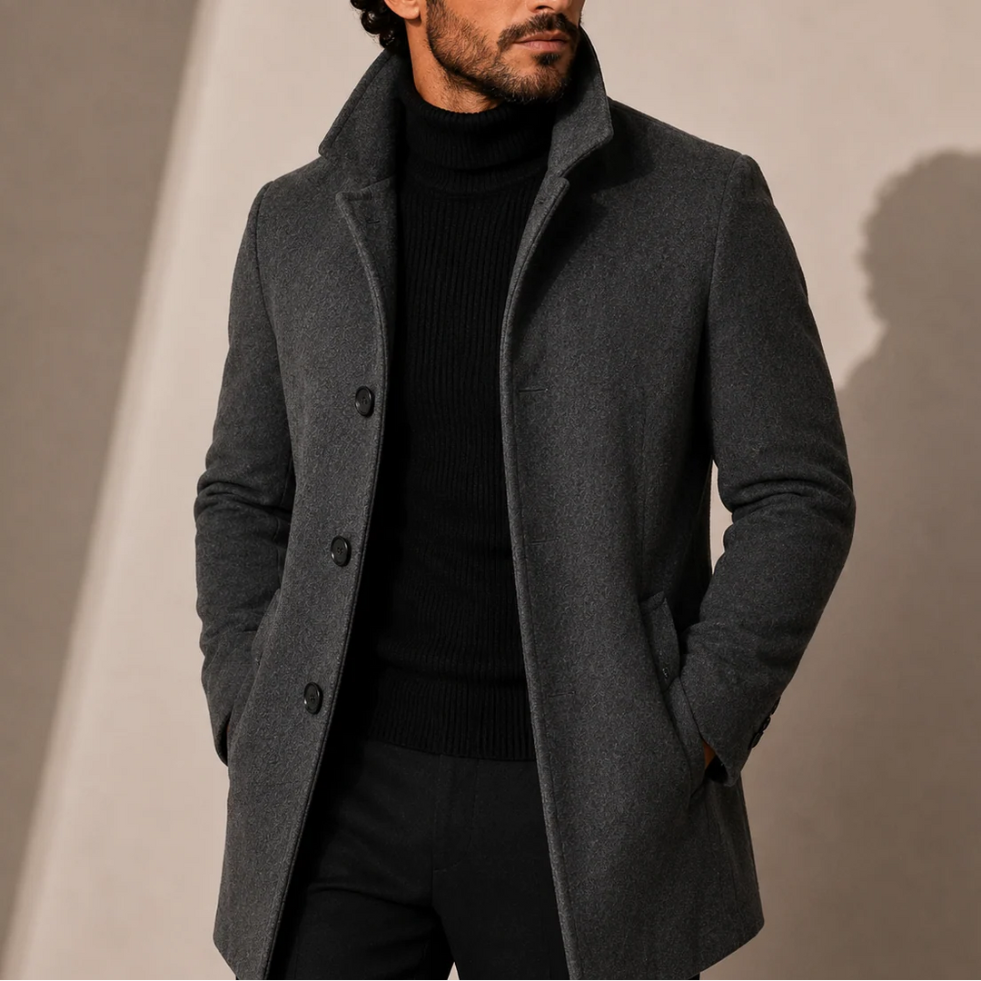 Side profile of men's tailored coat highlighting streamlined silhouette and mid-length cut