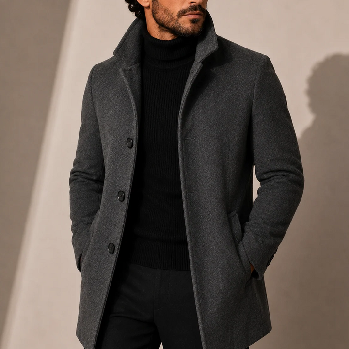 Side profile of men's tailored coat highlighting streamlined silhouette and mid-length cut