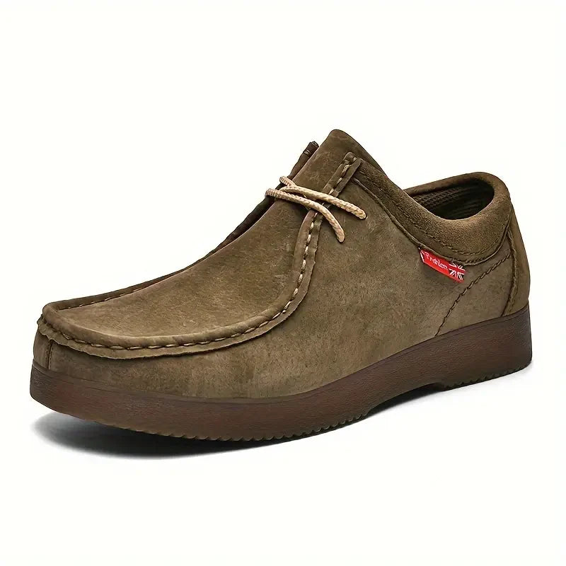Close-up of moc-toe stitching and structured upper on men's slip-on shoes