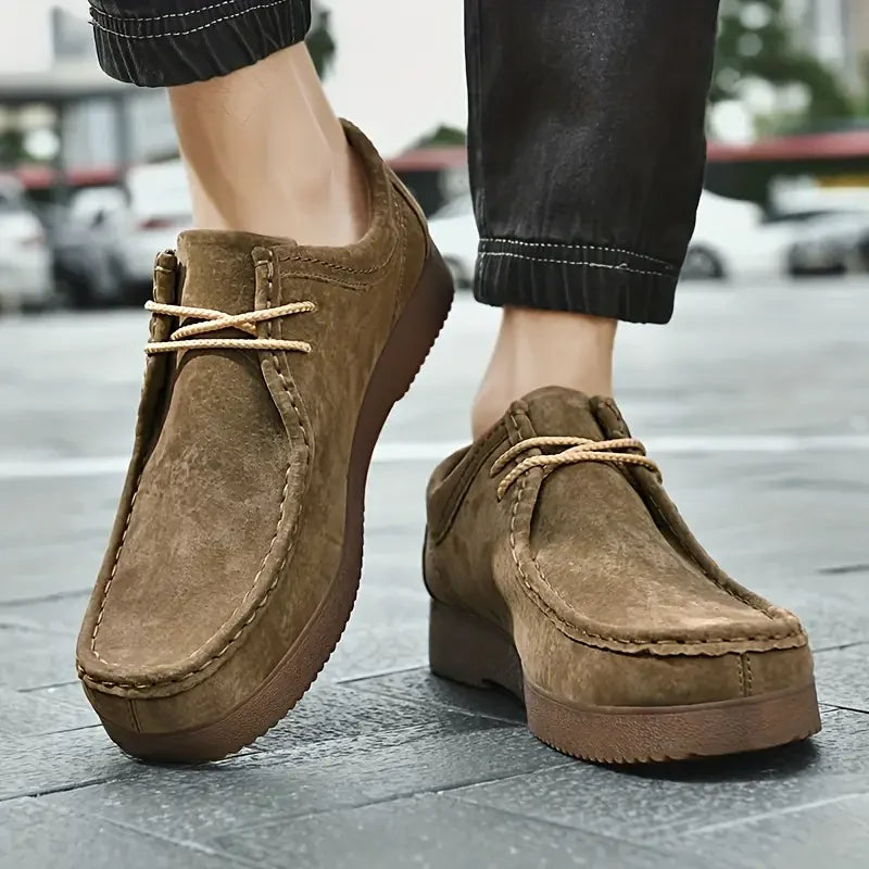Rear view of men's moccasin shoes displaying cushioned collar and heel construction