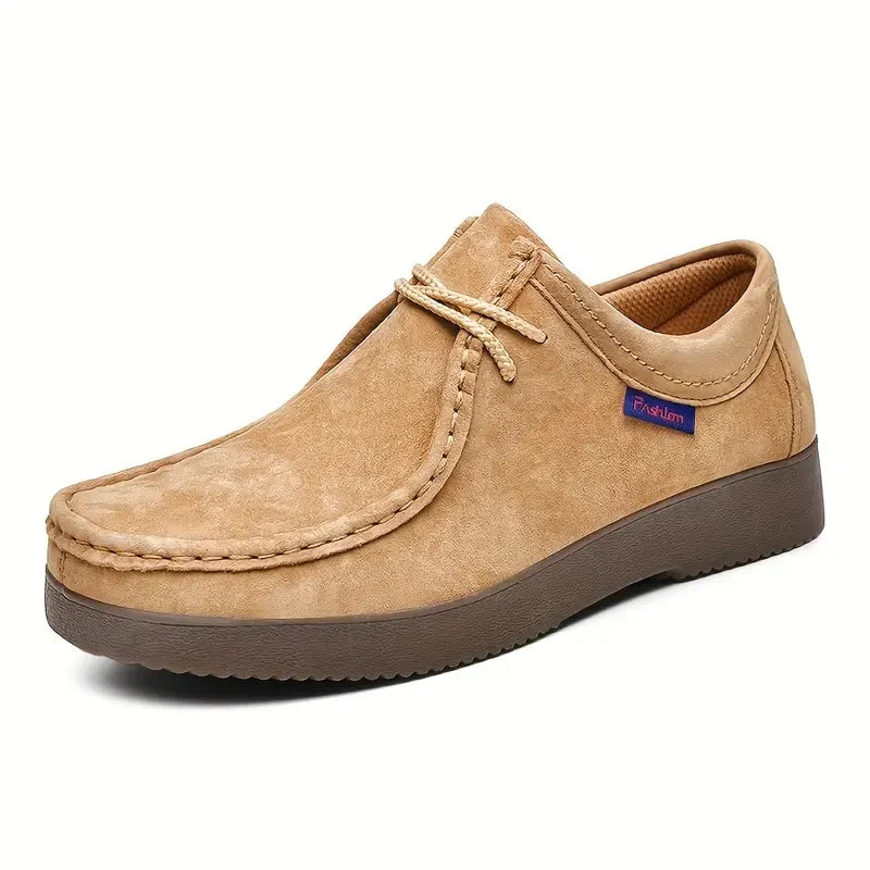 Men's moccasin shoes on textured surface highlighting non-slip rubber sole grip