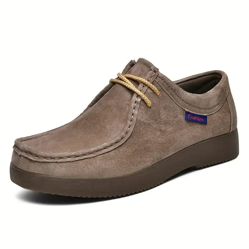 Detail of contrast stitching and rounded toe design on men's loafers